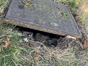 A drain cover in need of replacement in Stanmore.