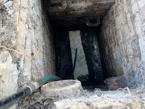 Cleaning blocked drain using high pressure water jetting