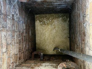 Drain jet cleaning to clear a blocked manhole in Edgware.