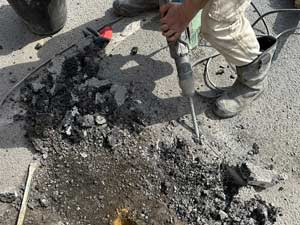 Excavating a buried manhole chamber London